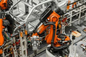 Car bodies are on assembly line. Factory for production of cars. Modern automotive industry